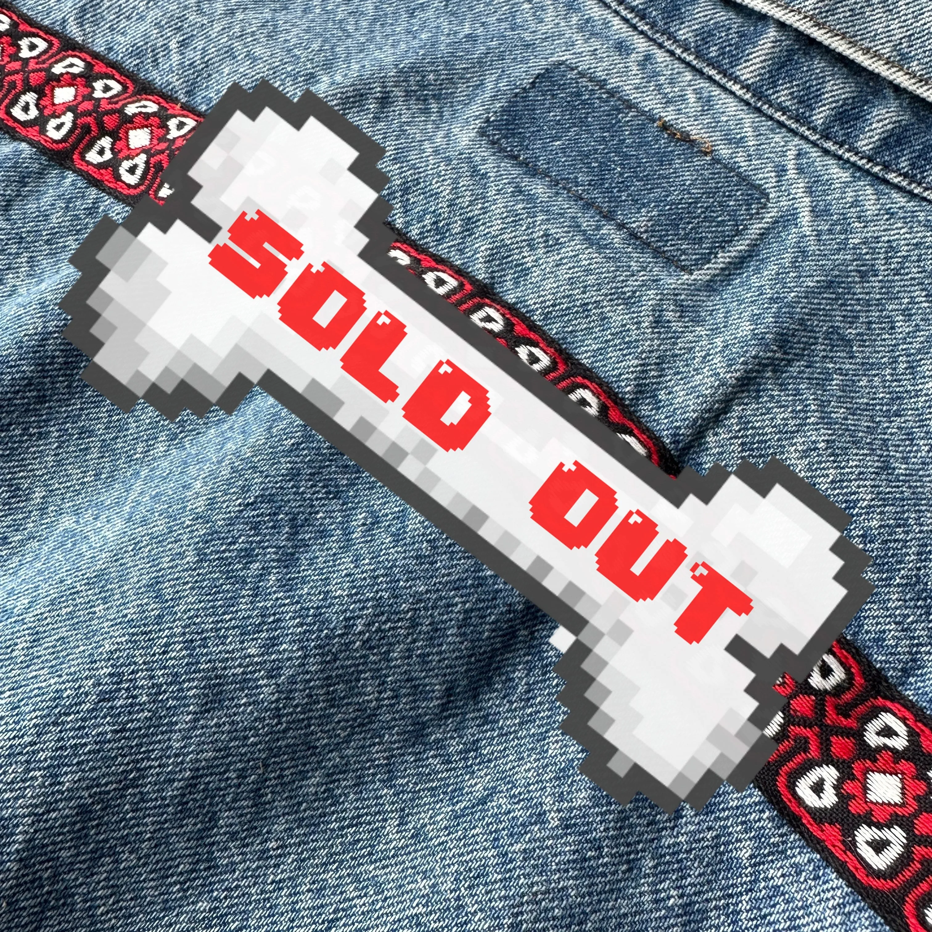 Levi's denim jacket with red, black, and white trim on front and back