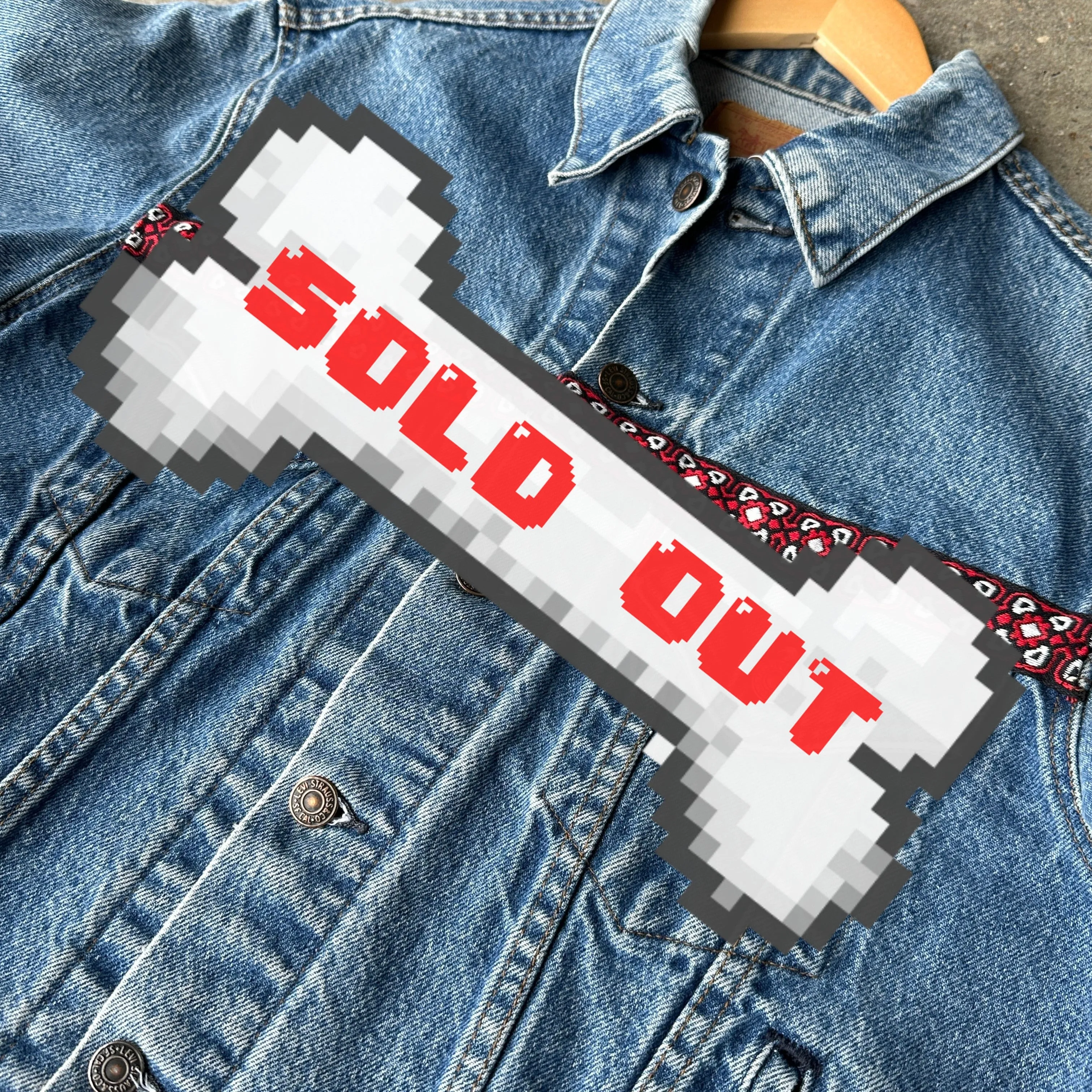 Levi's denim jacket with red, black, and white trim on front and back